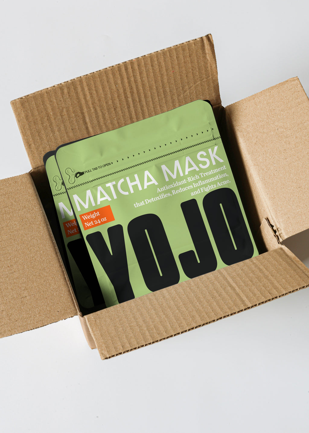Matcha mask packaging with 'YOJO' branding inside an open cardboard box.